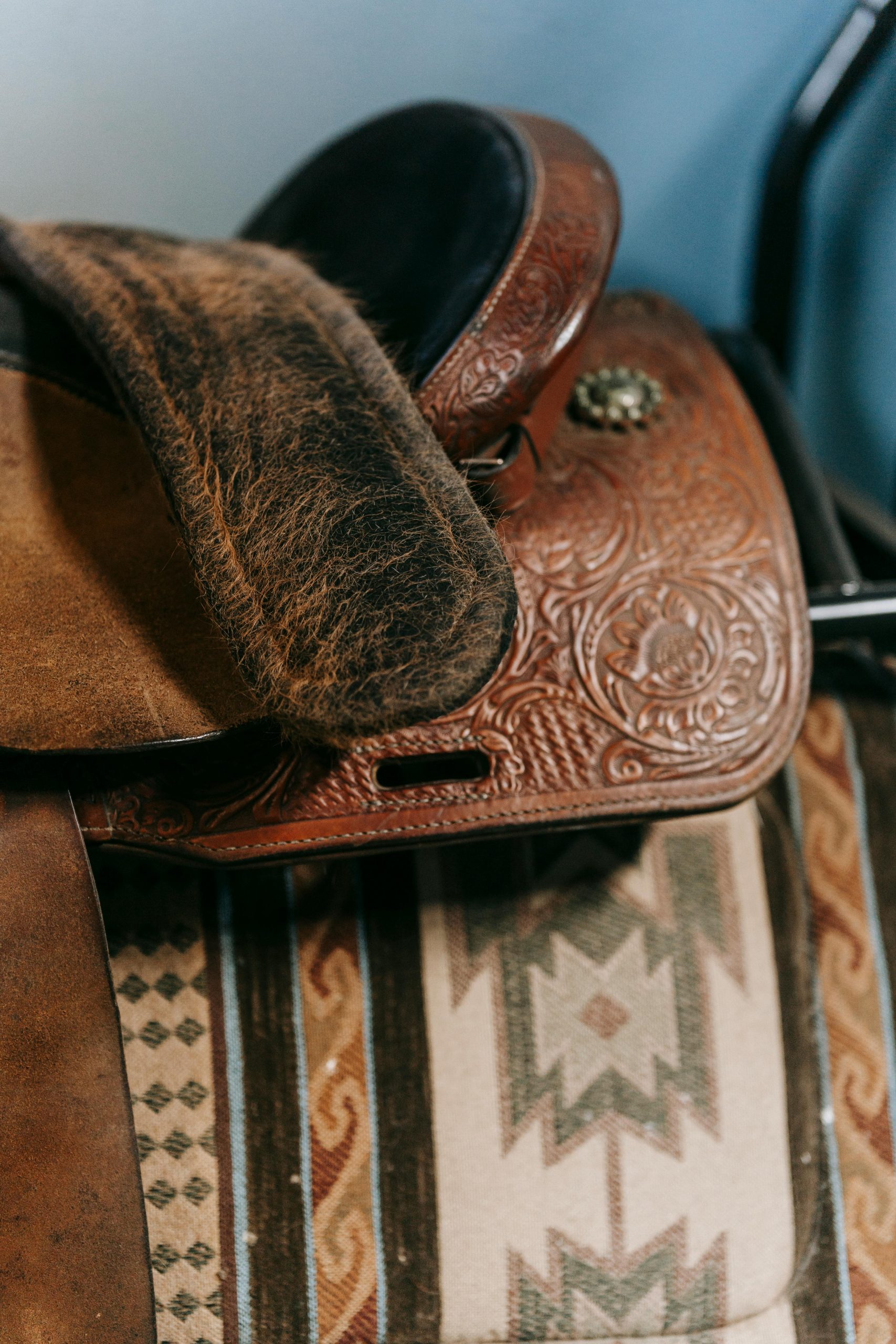 A beautifully detailed close-up of a leather horse saddle with intricate designs and textures.